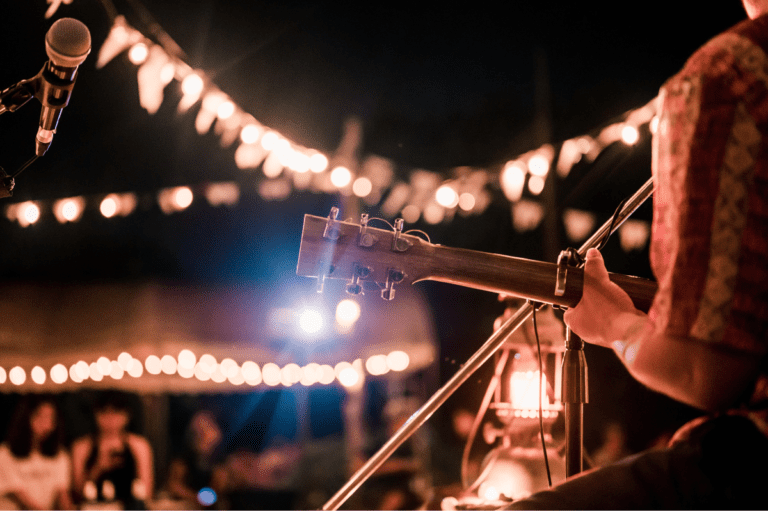 guitarist playing guitar in different festivals worldwide