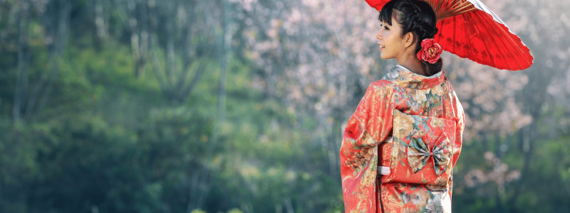 Girl holding a red umbrella in Japan